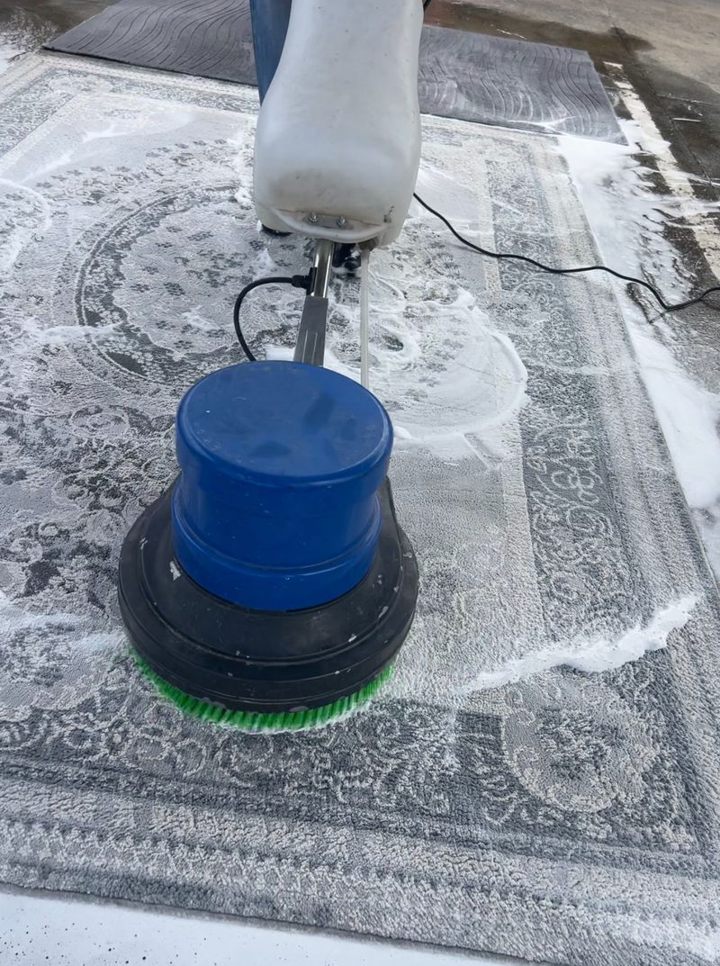 Hand-cleaning a Persian rug with specialist equipment at BTA Services